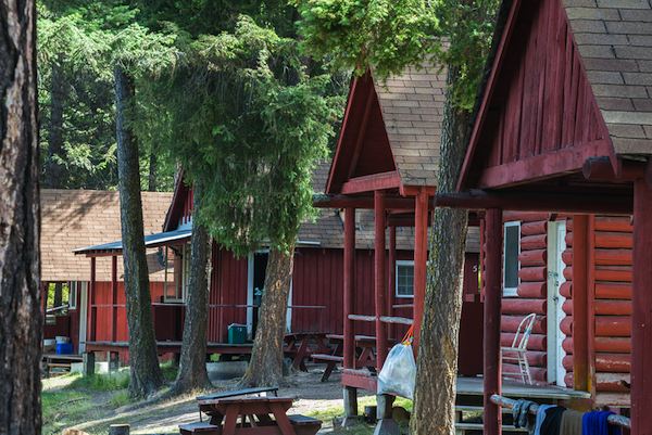 bigstock-Row-Of-Log-Cabins-at-a-Resort--49825445